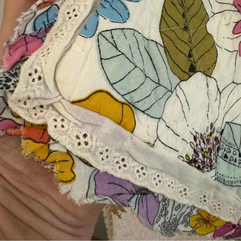 Cynthia Rowley quilted pillow sham with a multicolored boho floral pattern.